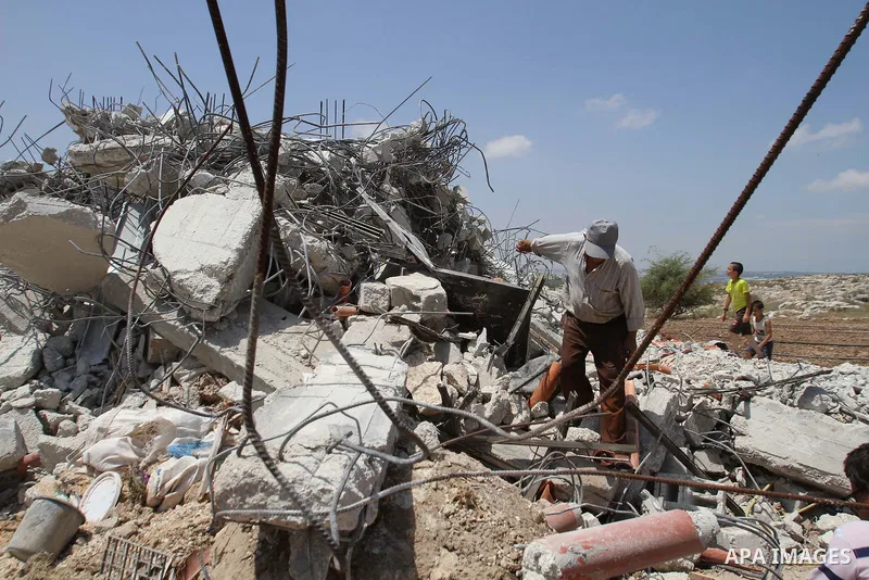 A Palestinian man inspects his house destroyed by the Israeli army bulldozers in Pharaoh village near the West Bank city of Tulkarem, on June 9, 2014. The Israeli army bulldozers demolished the house of a Palestinian fam...