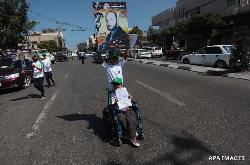 Palestinian boys form a human chain during a protest to support prisoners in Israeli jails, in Gaza city, on June 10, 2014. Palestinians jailed without trial in Israel are on a hunger strike since 24 April 2014, demandin...