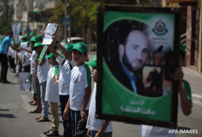 Palestinian boys form a human chain during a protest to support prisoners in Israeli jails, in Gaza city, on June 10, 2014. Palestinians jailed without trial in Israel are on a hunger strike since 24 April 2014, demandin...