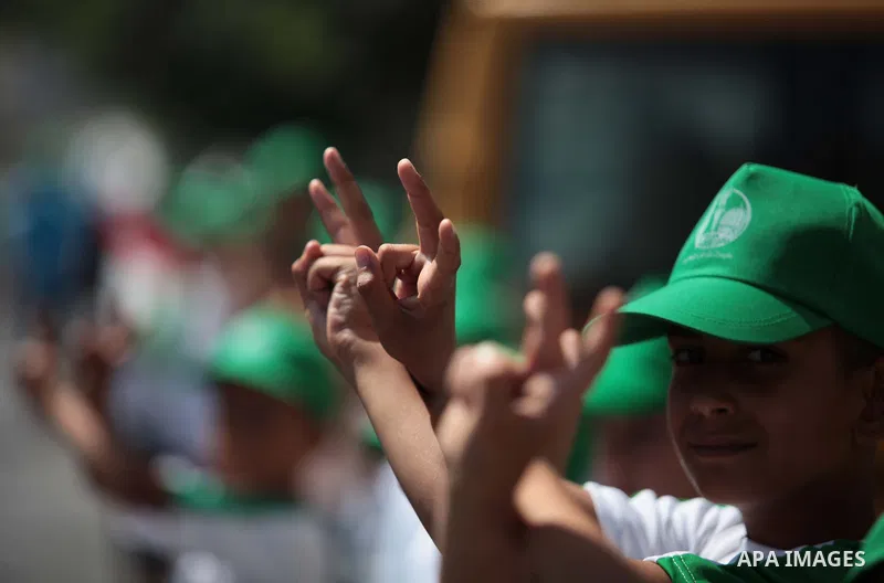 Palestinian boys form a human chain during a protest to support prisoners in Israeli jails, in Gaza city, on June 10, 2014. Palestinians jailed without trial in Israel are on a hunger strike since 24 April 2014, demandin...