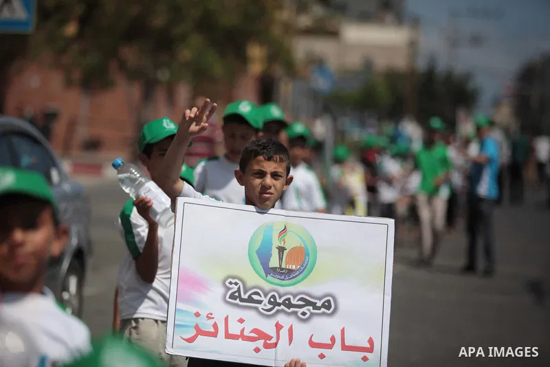 Palestinian boys form a human chain during a protest to support prisoners in Israeli jails, in Gaza city, on June 10, 2014. Palestinians jailed without trial in Israel are on a hunger strike since 24 April 2014, demandin...