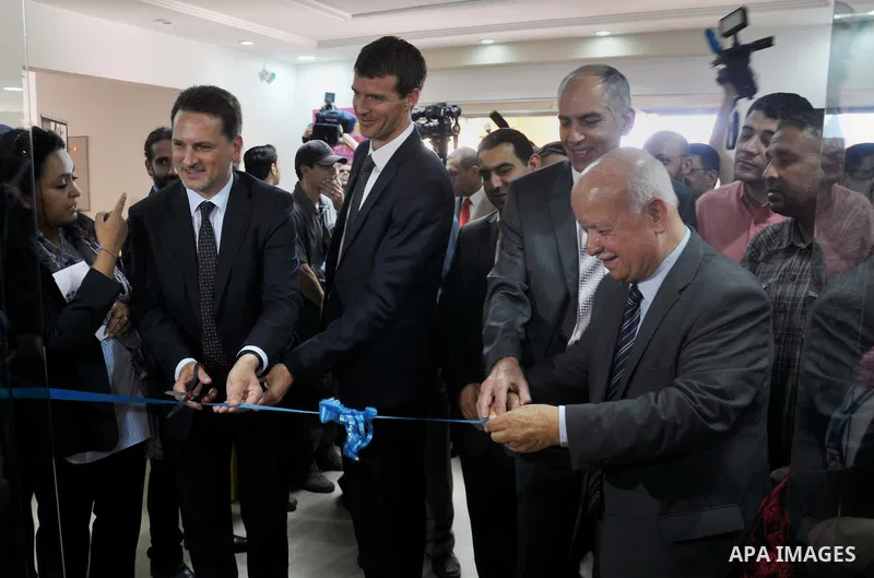 Member of the Executive Committee of the Palestine Liberation Organization, Zakaria al-Agha, takes part in the opening ceremony of the UNRWA gallery archive, in Gaza City on June 10, 2014. The gallery organized by the Un...