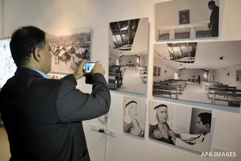 Palestinians take part in the opening ceremony of the UNRWA gallery archive, in Gaza City on June 10, 2014. The gallery organized by the United Nations Relief and Works Agency (UNRWA) digitized to preserve a record of on...