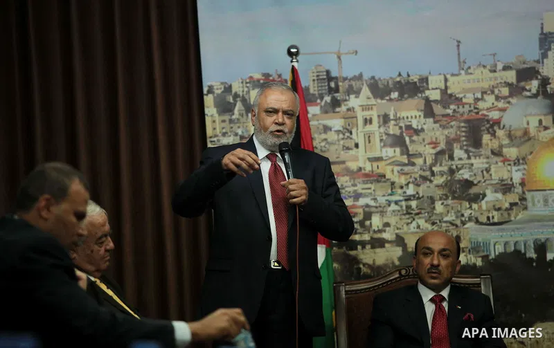 Palestinian Justice Minister of the new unity government, Salim al-Sakka, speaks during the handover ceremony of the headquarters of the Council of Ministers, in Gaza City on June 11, 2014. The unity government was sworn...