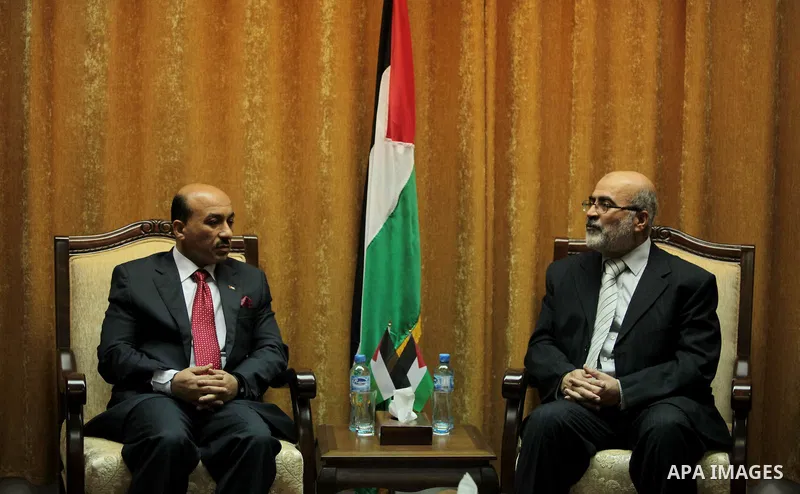 Former deputy premier of the government in Gaza Strip Ziad Thatha (R), meets with Palestinian Minister of public works and housing of the new unity government, Mufid al-Hasayna during the handover ceremony of the headqua...