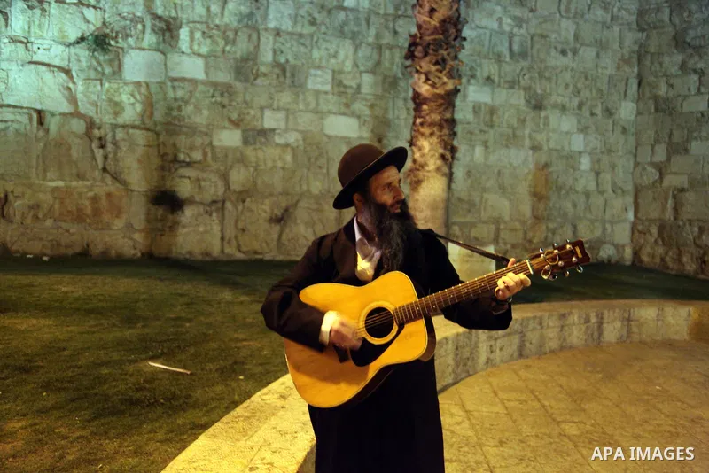 An Ultra-Orthodox Jewish participates in a show during the Jerusalem Lights Festival, in the Old City of Jerusalem, early 12 June 2014. The festival, hosting Israeli and international artists and creators, opened on late...