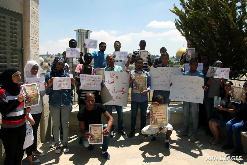 Palestinian relatives and friends of prisoner Mohammed Firawi, 17, hold placards during a protest in front the office of the Ministry of Education, in Jerusalem's Old City on June 11, 2014. Palestinians protest against t...