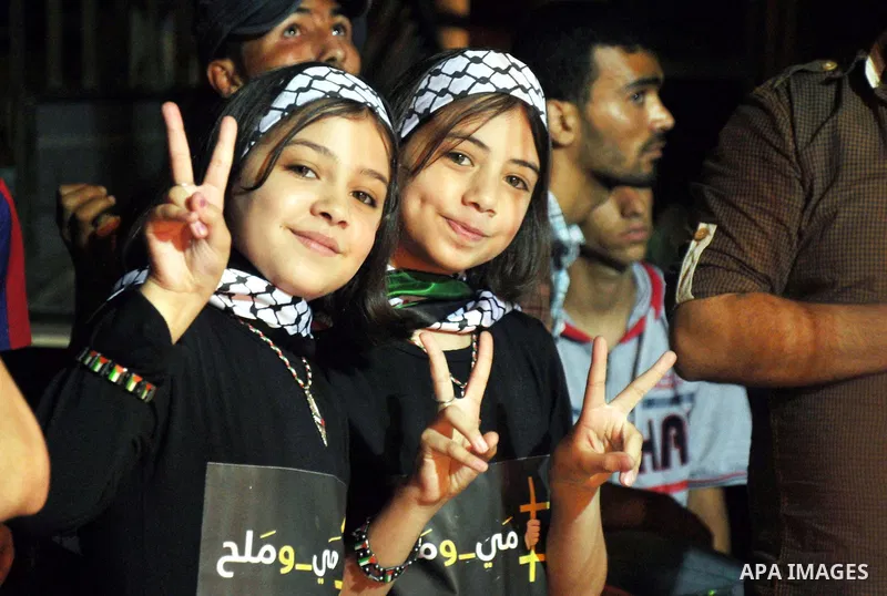 Palestinian girls flash victory sign during a celebration to show solidarity with 125 Palestinian prisoners detained in Israeli jails and who have been on hunger strike for 51 days, in Gaza City June 12, 2014. Some 285 P...