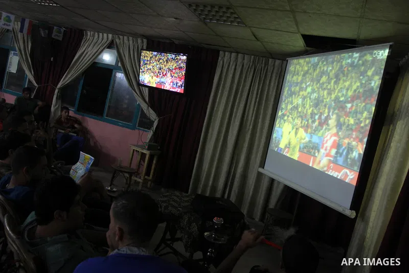 Palestinians watch the opening match of the 2014 FIFA World Cup between Brazil and Croatia being played at the Corinthians Arena in Sao Paulo, at a cafe in Gaza City on June 12, 2014. The FIFA World Cup 2014 will take pl...