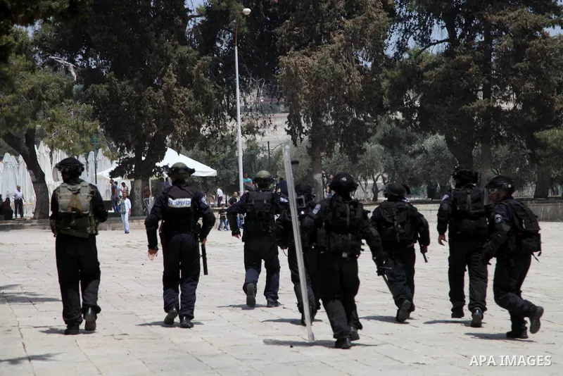 Israeli riot police run after Palestinian youths during clashes following Friday prayers at the al-Aqsa mosque compound in Jerusalem's Old City on June 13, 2014. Photo by Saeed Qaq