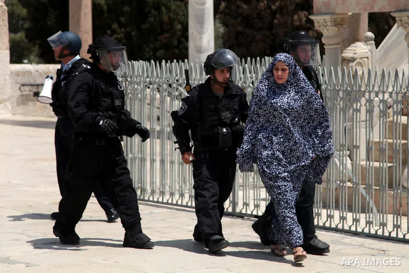 Israeli riot police detain a Palestinian woman during clashes following Friday prayers at the al-Aqsa mosque compound in Jerusalem's Old City on June 13, 2014. Photo by Saeed Qaq