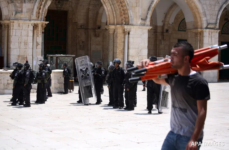 Israeli riot police take position during clashes with Palestinian youths following Friday prayers at the al-Aqsa mosque compound in Jerusalem's Old City on June 13, 2014. Photo by Saeed Qaq