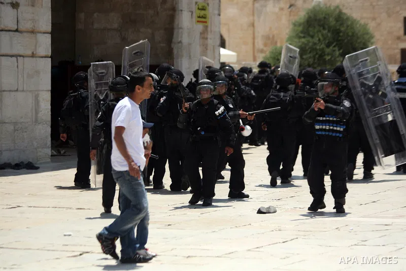 Israeli riot police take position during clashes with Palestinian youths following Friday prayers at the al-Aqsa mosque compound in Jerusalem's Old City on June 13, 2014. Photo by Saeed Qaq