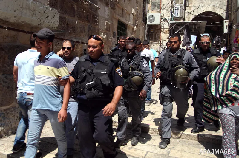 Israeli riot police detain a Palestinian youth during clashes following Friday prayers at the al-Aqsa mosque compound in Jerusalem's Old City on June 13, 2014. Photo by Saeed Qaq