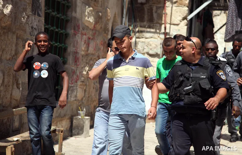 Israeli riot police detain a Palestinian youth during clashes following Friday prayers at the al-Aqsa mosque compound in Jerusalem's Old City on June 13, 2014. Photo by Saeed Qaq