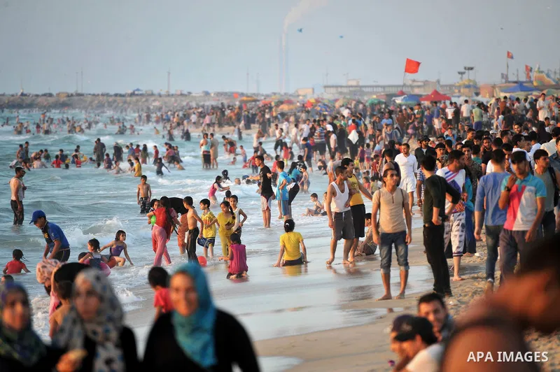 Palestinians enjoy a summer day at the beach in Gaza city, on June 13, 2014. Friday is the Muslim holiday and as summer is entering many Palestinian people go to the beach since it is the major entertainment area in the...