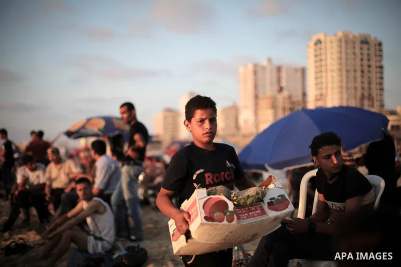 Palestinians enjoy a summer day at the beach in Gaza city, on June 13, 2014. Friday is the Muslim holiday and as summer is entering many Palestinian people go to the beach since it is the major entertainment area in the...