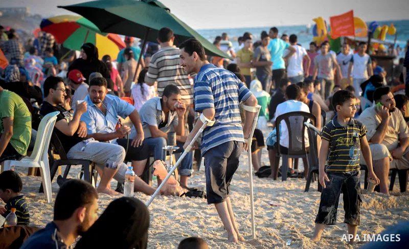 Palestinians enjoy a summer day at the beach in Gaza city, on June 13, 2014. Friday is the Muslim holiday and as summer is entering many Palestinian people go to the beach since it is the major entertainment area in the...