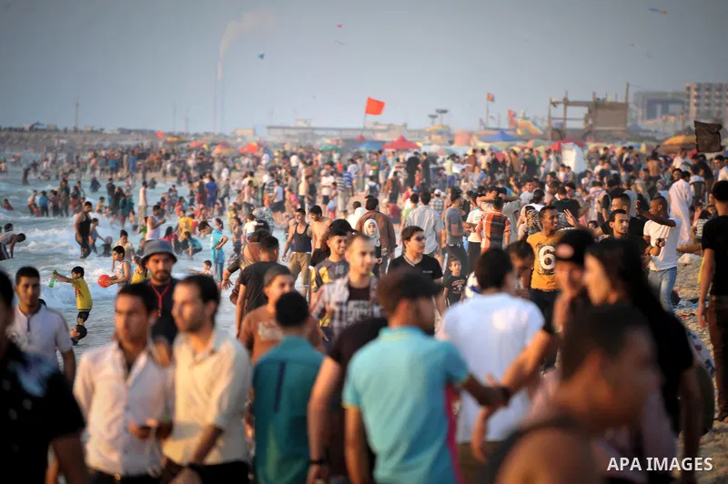Palestinians enjoy a summer day at the beach in Gaza city, on June 13, 2014. Friday is the Muslim holiday and as summer is entering many Palestinian people go to the beach since it is the major entertainment area in the...