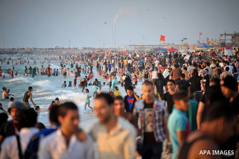 Palestinians enjoy a summer day at the beach in Gaza city, on June 13, 2014. Friday is the Muslim holiday and as summer is entering many Palestinian people go to the beach since it is the major entertainment area in the...