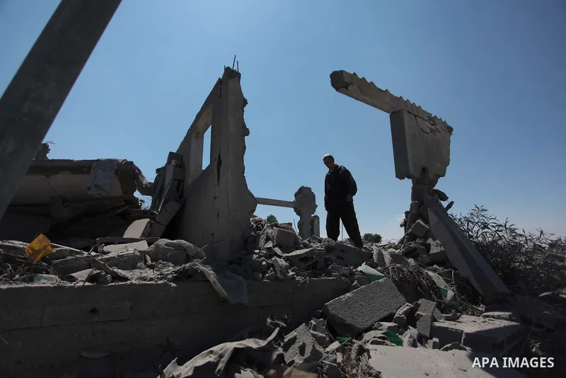 A Palestinian man inspects the sites of an Israeli air strike in Rafah in the southern Gaza Strip June 15, 2014. Israeli strikes come only three days after Israeli air forces targeted a Palestinian individual associated...