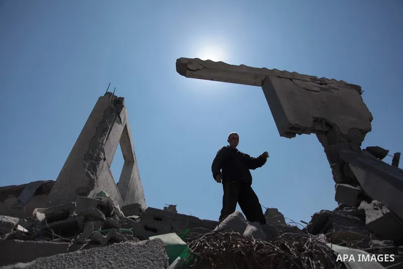 A Palestinian man inspects the sites of an Israeli air strike in Rafah in the southern Gaza Strip June 15, 2014. Israeli strikes come only three days after Israeli air forces targeted a Palestinian individual associated...