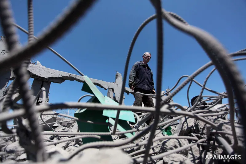 A Palestinian man inspects the sites of an Israeli air strike in Rafah in the southern Gaza Strip June 15, 2014. Israeli strikes come only three days after Israeli air forces targeted a Palestinian individual associated...