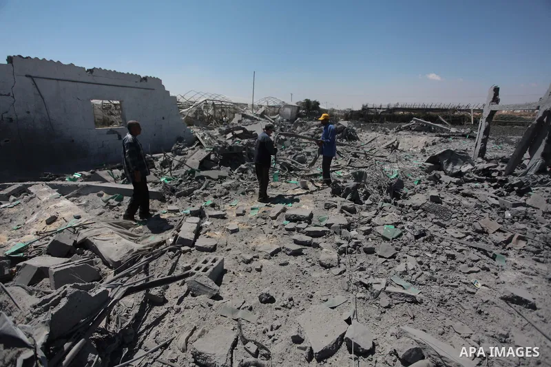 Palestinian men inspect the sites of an Israeli air strike in Rafah in the southern Gaza Strip June 15, 2014. Israeli strikes come only three days after Israeli air forces targeted a Palestinian individual associated wit...