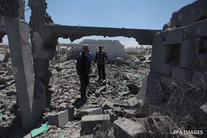 Palestinian men inspect the sites of an Israeli air strike in Rafah in the southern Gaza Strip June 15, 2014. Israeli strikes come only three days after Israeli air forces targeted a Palestinian individual associated wit...