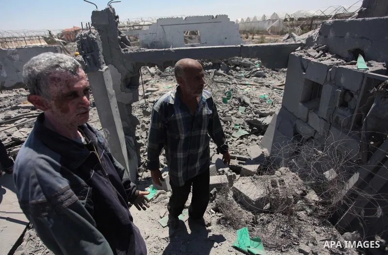 Palestinian men inspect the sites of an Israeli air strike in Rafah in the southern Gaza Strip June 15, 2014. Israeli strikes come only three days after Israeli air forces targeted a Palestinian individual associated wit...