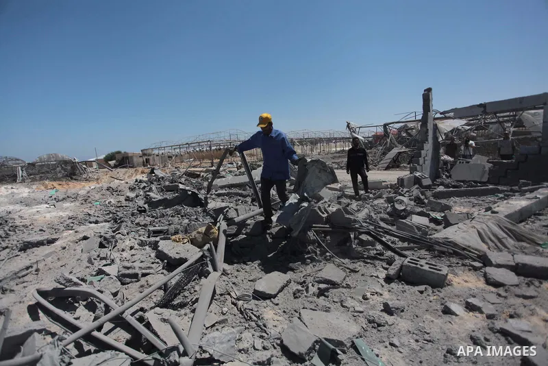 Palestinian men inspect the sites of an Israeli air strike in Rafah in the southern Gaza Strip June 15, 2014. Israeli strikes come only three days after Israeli air forces targeted a Palestinian individual associated wit...