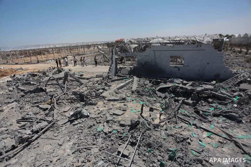 Palestinian men inspect the sites of an Israeli air strike in Rafah in the southern Gaza Strip June 15, 2014. Israeli strikes come only three days after Israeli air forces targeted a Palestinian individual associated wit...
