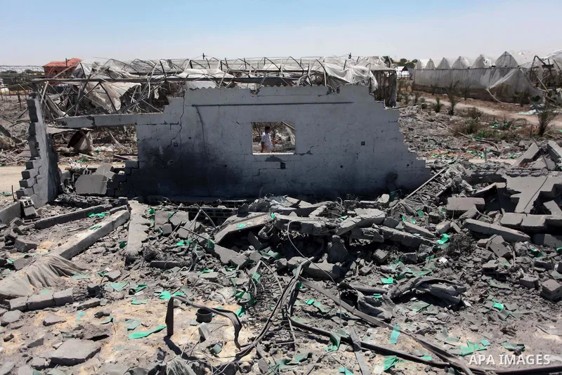 A Palestinian man inspects the sites of an Israeli air strike in Rafah in the southern Gaza Strip June 15, 2014. Israeli strikes come only three days after Israeli air forces targeted a Palestinian individual associated...