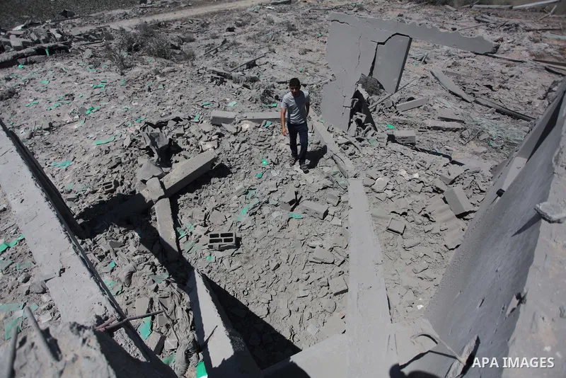 A Palestinian man inspects the sites of an Israeli air strike in Rafah in the southern Gaza Strip June 15, 2014. Israeli strikes come only three days after Israeli air forces targeted a Palestinian individual associated...