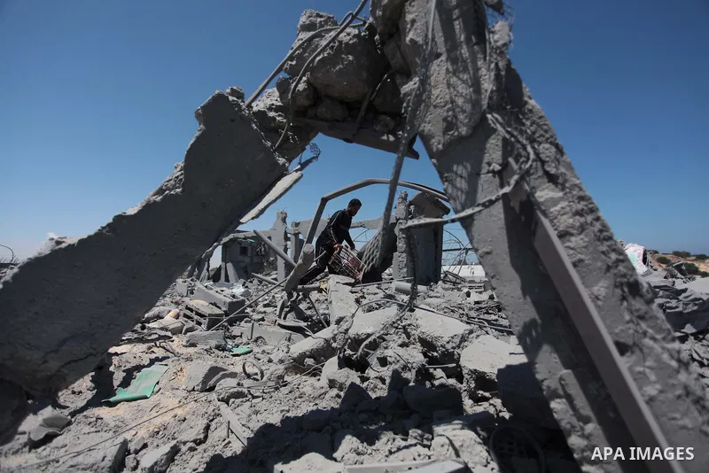 A Palestinian man inspects the sites of an Israeli air strike in Rafah in the southern Gaza Strip June 15, 2014. Israeli strikes come only three days after Israeli air forces targeted a Palestinian individual associated...