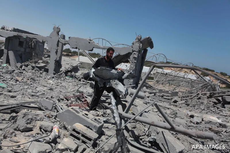 A Palestinian man inspects the sites of an Israeli air strike in Rafah in the southern Gaza Strip June 15, 2014. Israeli strikes come only three days after Israeli air forces targeted a Palestinian individual associated...