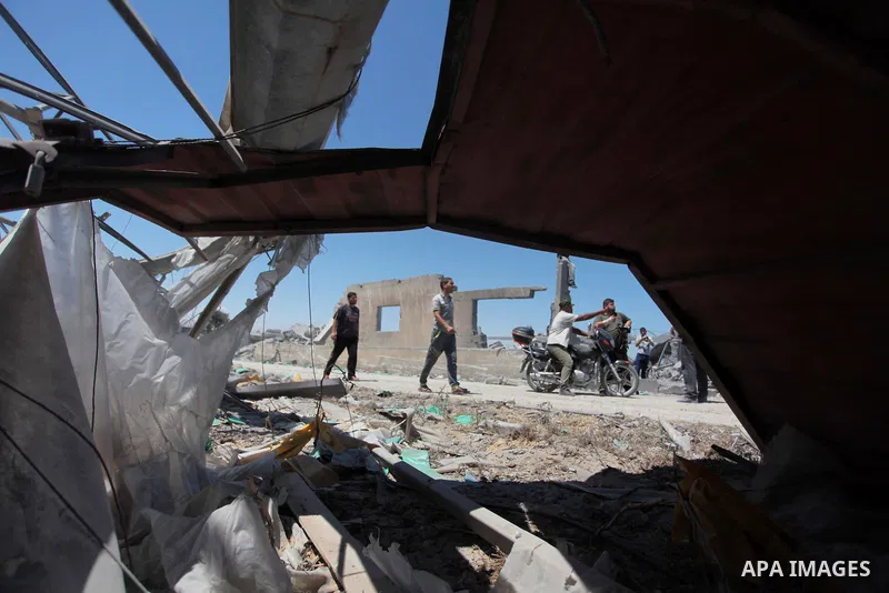 Palestinian men inspect the sites of an Israeli air strike in Rafah in the southern Gaza Strip June 15, 2014. Israeli strikes come only three days after Israeli air forces targeted a Palestinian individual associated wit...
