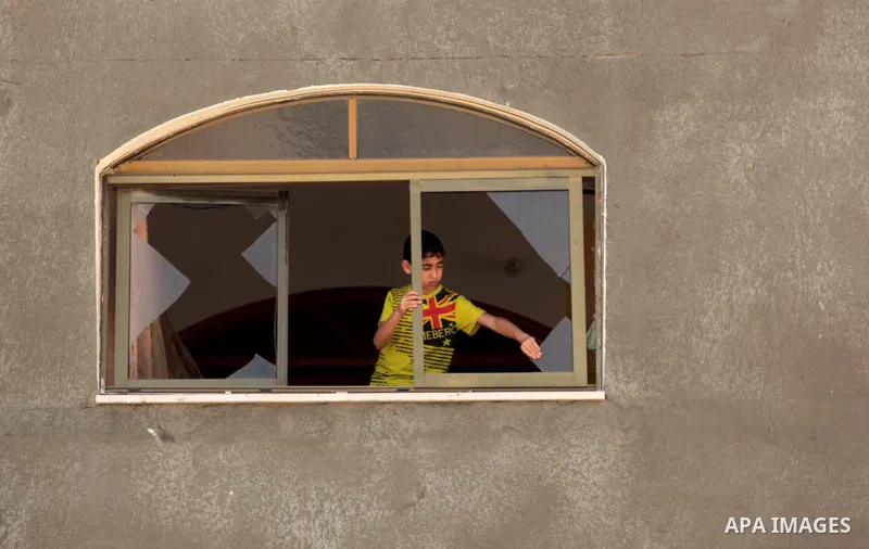 A Palestinian boy inspects his window following an air strike by the Israeli airforce on Gaza City, on June 16, 2014. Israel launched air strikes on different areas of on Gaza Strip, as Israeli troops killed a Palestinia...