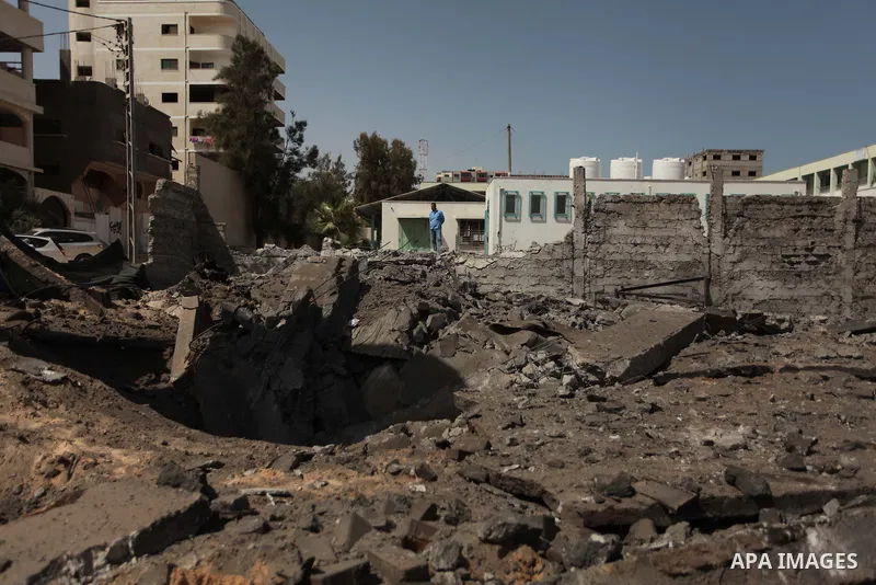 A Palestinian man looks a crater following an air strike by Israeli airforce on Gaza City on June 16, 2014. Israel launched air strikes on different areas of on Gaza Strip, as Israeli troops killed a Palestinian and arre...