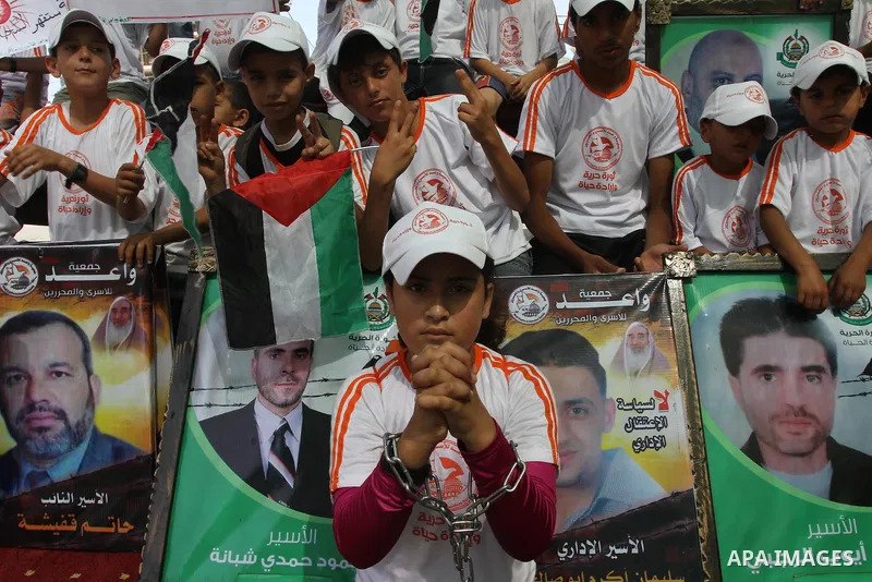 Palestinian children take part in a protest in support of 125 Palestinian prisoners detained in Israeli jails and who have been on hunger strike for 55 days, in front of the Red cross office in Gaza City on June 16, 2014...