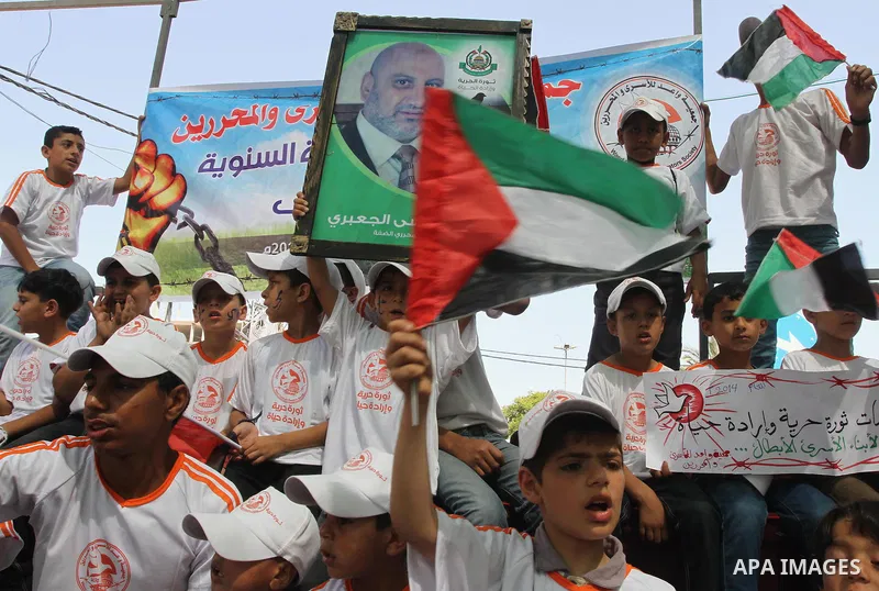Palestinian children take part in a protest in support of 125 Palestinian prisoners detained in Israeli jails and who have been on hunger strike for 55 days, in front of the Red cross office in Gaza City on June 16, 2014...