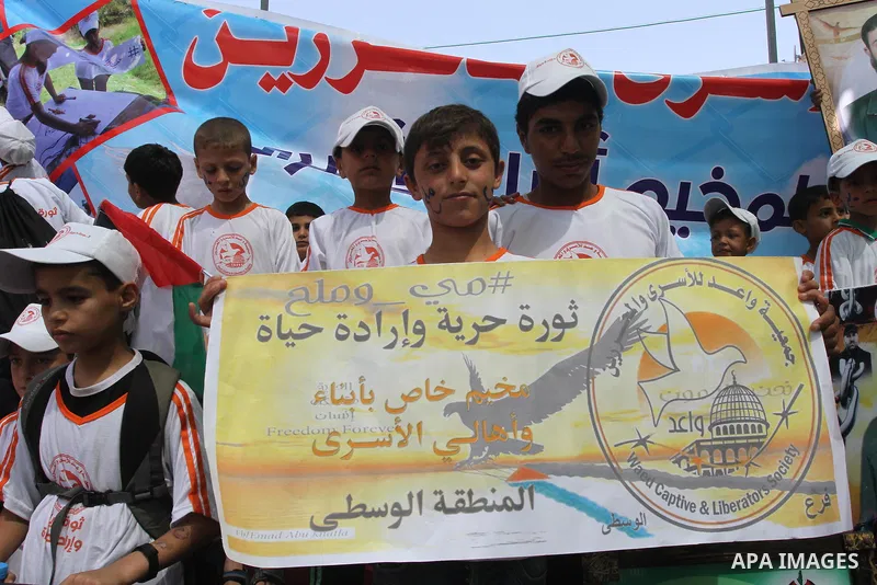 Palestinian children take part in a protest in support of 125 Palestinian prisoners detained in Israeli jails and who have been on hunger strike for 55 days, in front of the Red cross office in Gaza City on June 16, 2014...