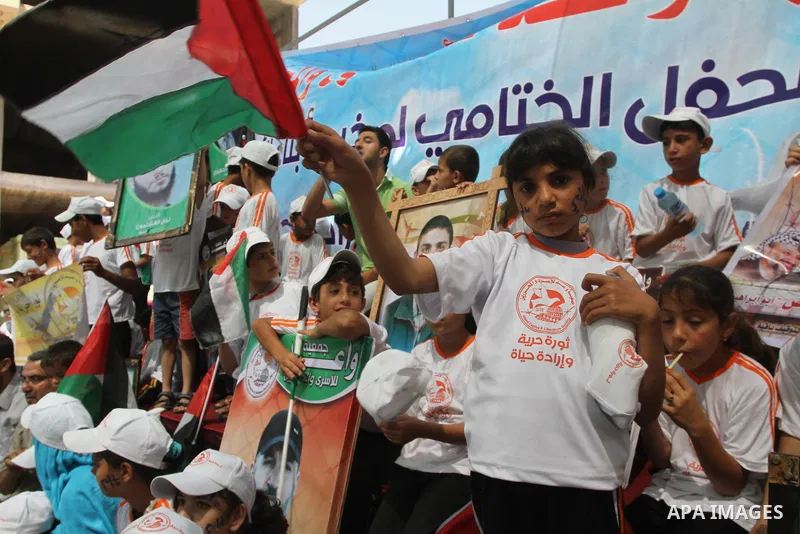 Palestinian children take part in a protest in support of 125 Palestinian prisoners detained in Israeli jails and who have been on hunger strike for 55 days, in front of the Red cross office in Gaza City on June 16, 2014...