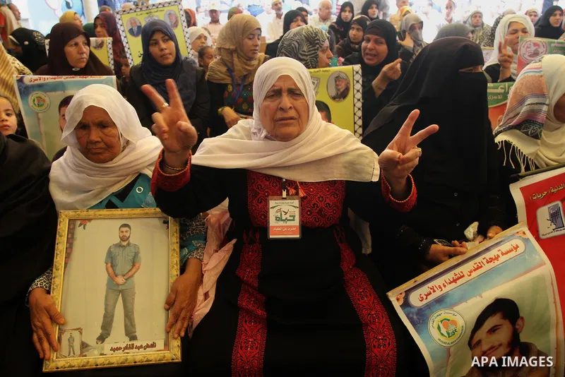 Palestinians take part in a protest in support of 125 Palestinian prisoners detained in Israeli jails and who have been on hunger strike for 55 days, in front of the Red cross office in Gaza City on June 16, 2014. Some 2...