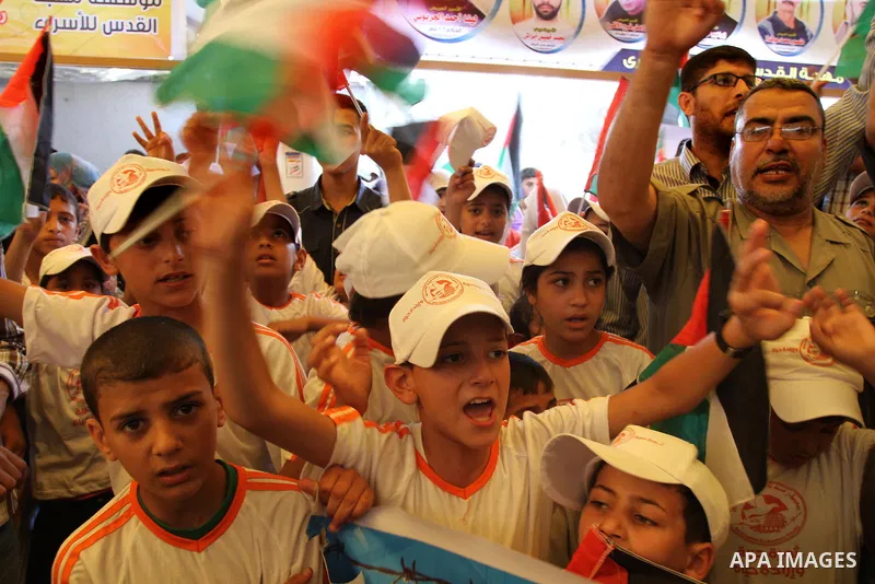 Palestinian children take part in a protest in support of 125 Palestinian prisoners detained in Israeli jails and who have been on hunger strike for 55 days, in front of the Red cross office in Gaza City on June 16, 2014...