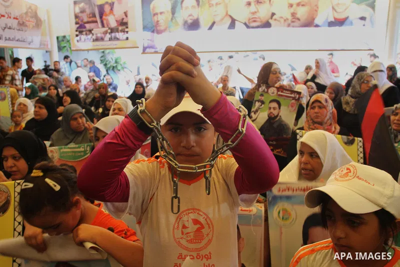 Palestinian children take part in a protest in support of 125 Palestinian prisoners detained in Israeli jails and who have been on hunger strike for 55 days, in front of the Red cross office in Gaza City on June 16, 2014...