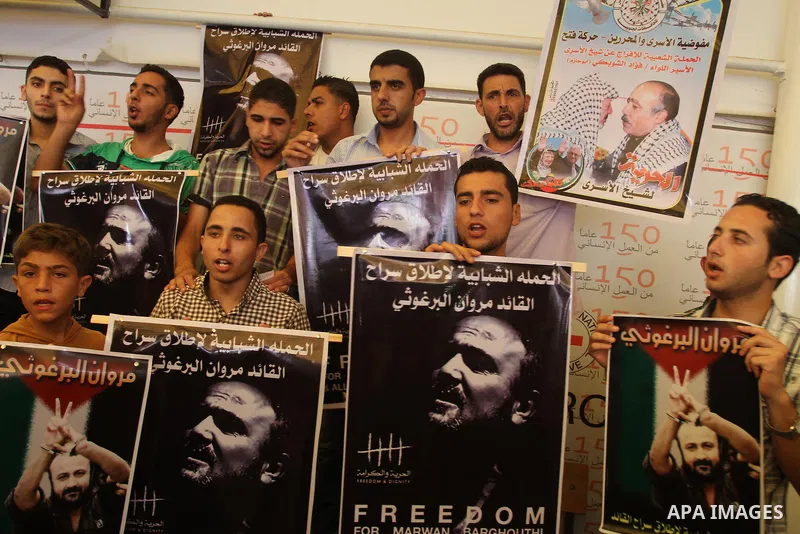 Palestinians take part in a protest in support of 125 Palestinian prisoners detained in Israeli jails and who have been on hunger strike for 55 days, in front of the Red cross office in Gaza City on June 16, 2014. Some 2...