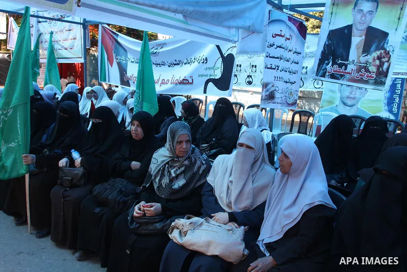 Palestinians take part in a protest in support of 125 Palestinian prisoners detained in Israeli jails and who have been on hunger strike for 55 days, in front of the Red cross office in Gaza City on June 16, 2014. Some 2...