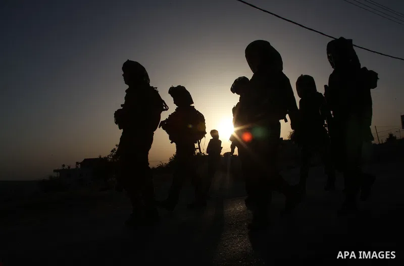 Israeli troops take part in a search operation on the outskirts of the West Bank town of Hebron on June 16,2014 as security forces broadened the search for three teenagers believed kidnapped by Palestinian militants and...