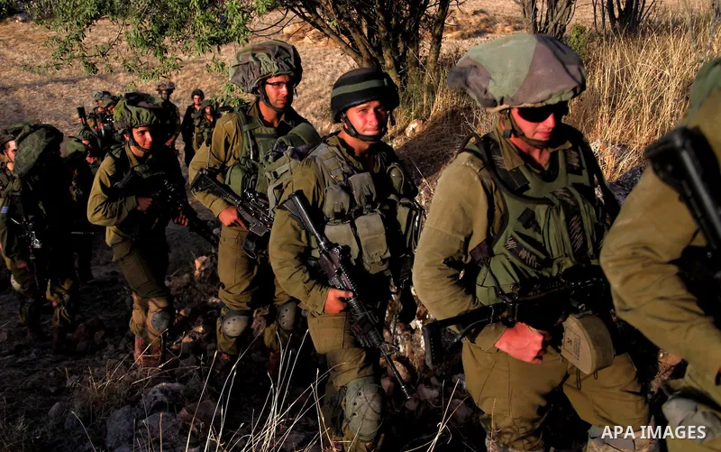 Israeli troops take part in a search operation on the outskirts of the West Bank town of Hebron on June 16,2014 as security forces broadened the search for three teenagers believed kidnapped by Palestinian militants and...